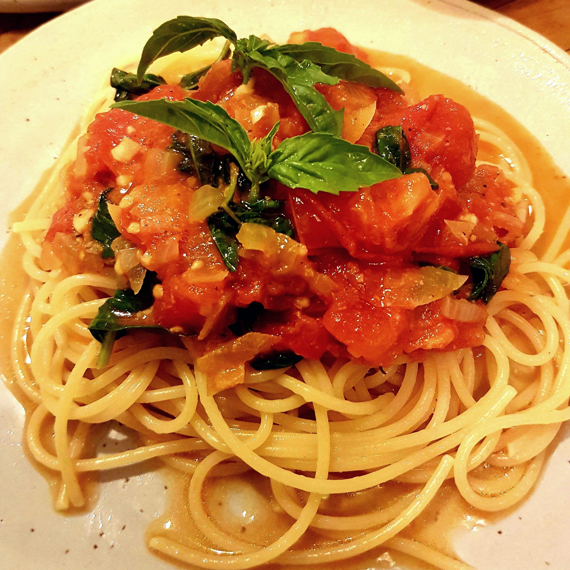 Spaghetti topped with a fresh heirloom tomato and basil sauce